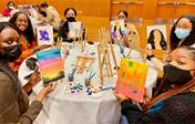 Students painting at an event