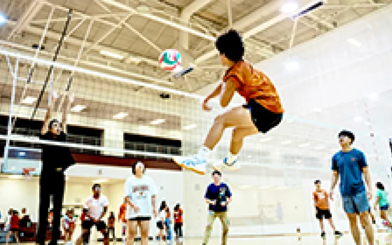 Students playing volleyball at Greg Gym